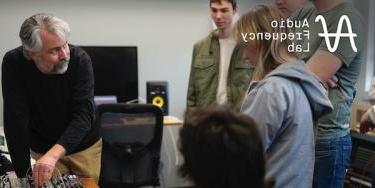 Link to Audio Frequency Lab page with image of professor demonstrating a synthesizer for students